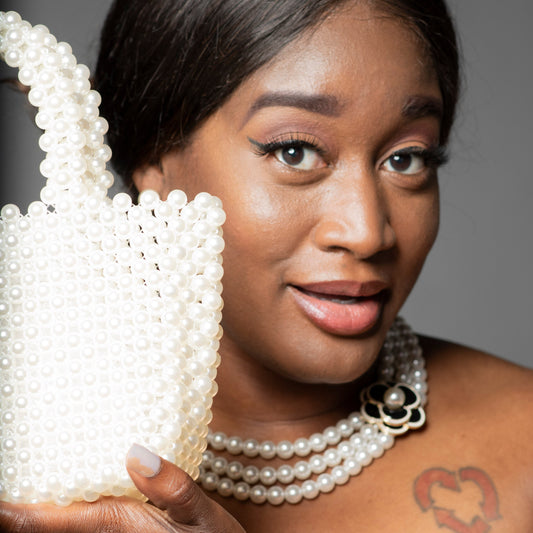 Model holding Off-White Pearl Handbag