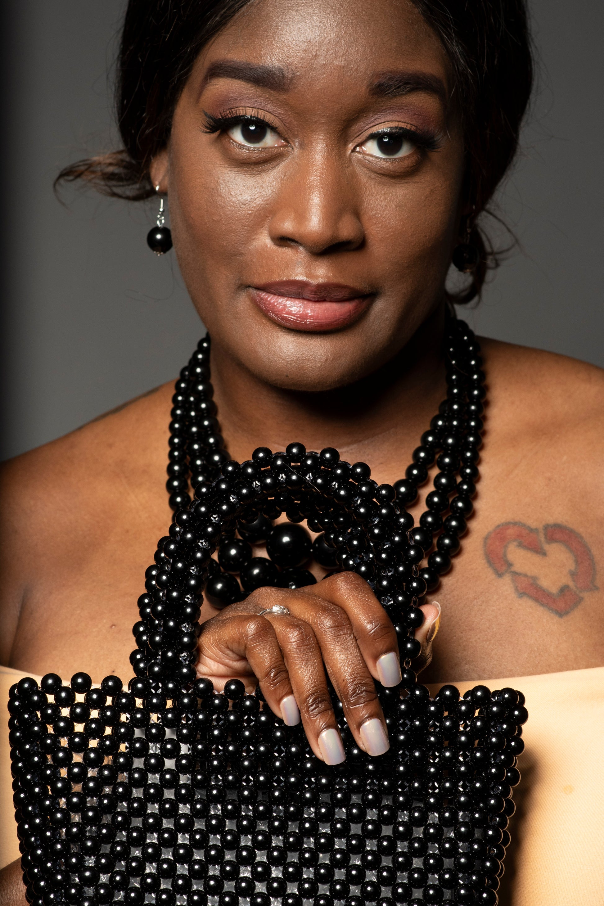 Model holding the Black Pearl Handbag